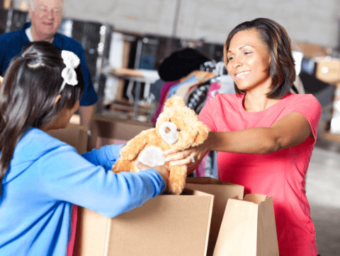 stuffed animal being placed in a cardboard box